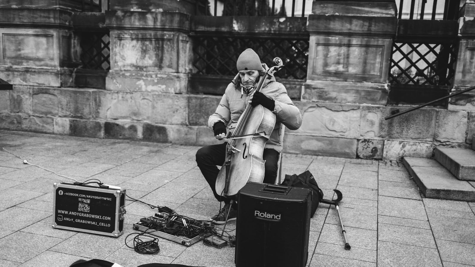 A musician safely transporting a cello in a professional protective case